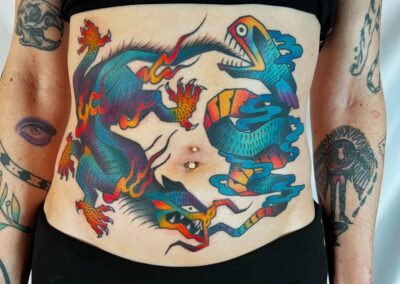 Lydia Kinsey's tattoo depicting a full-color snake and dragon.